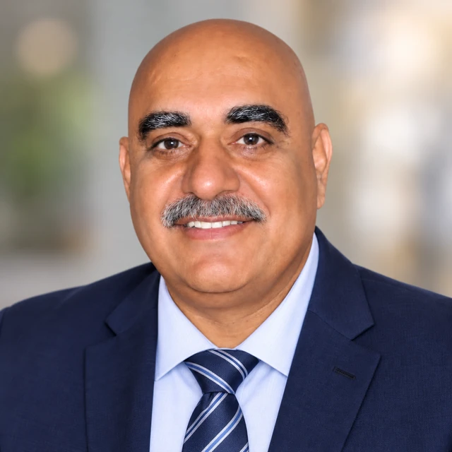 Jash Puniya, Sales Representative, smiling in a navy suit